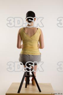 Sitting reference of whole body yellow t shirt gray shorts…